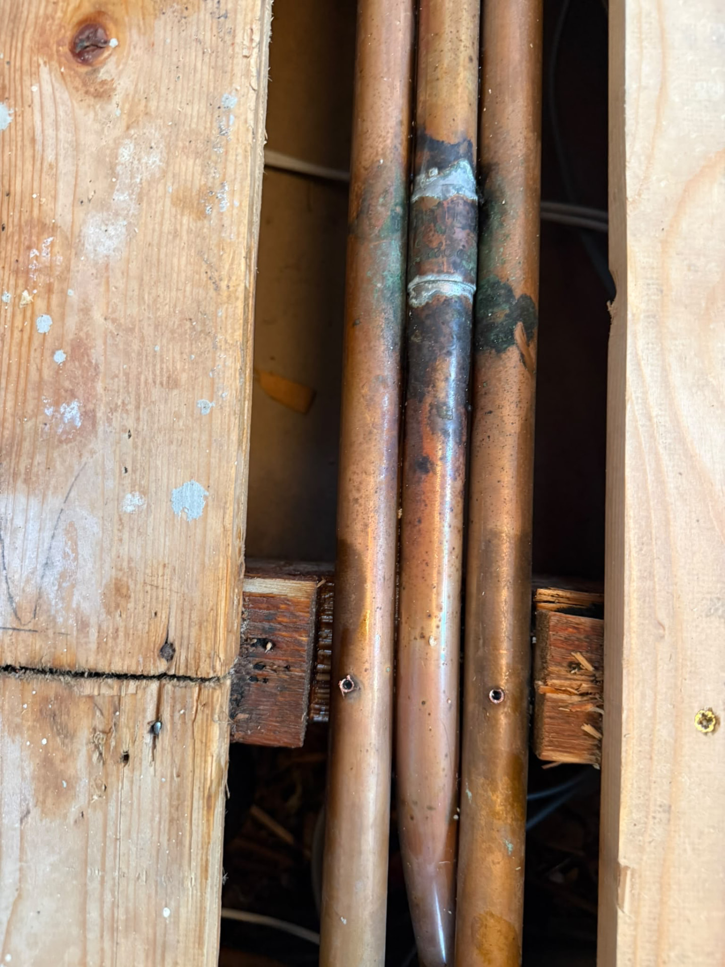 Corroded, leaking copper pipe joint inside a wall