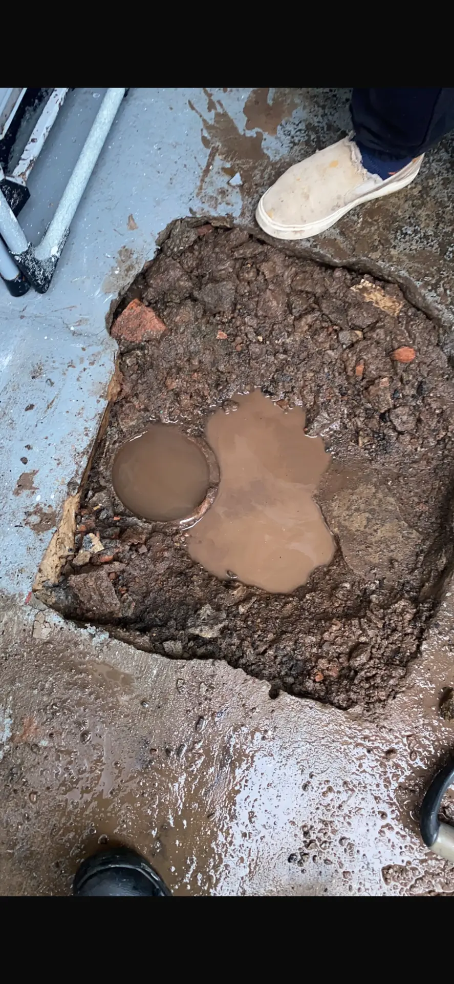 Flooded excavation over a leaking underground pipe