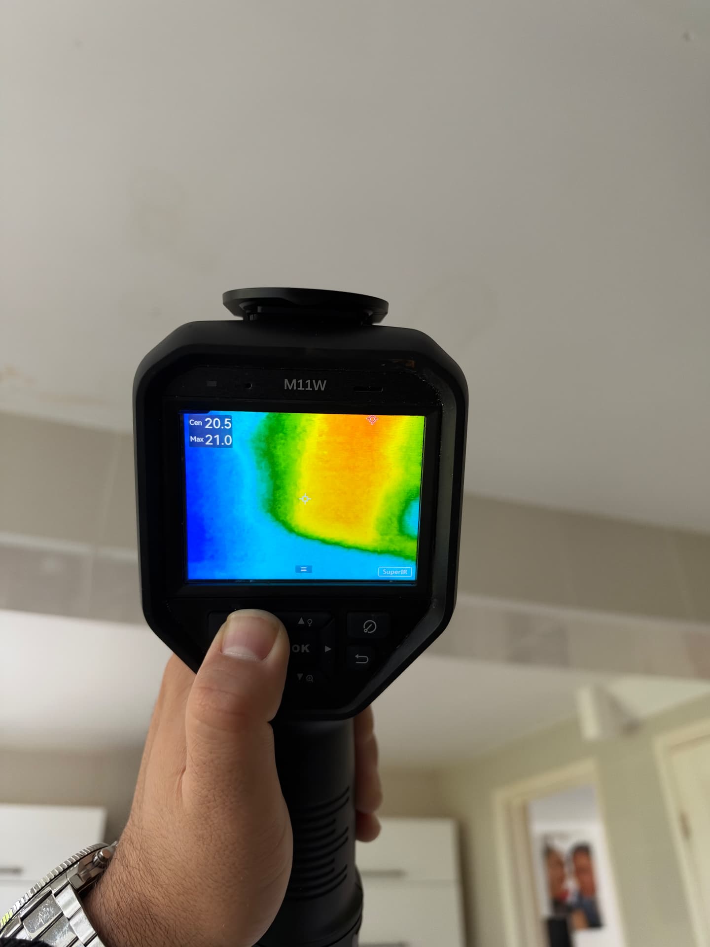 Thermal camera pinpointing the leak above the ceiling